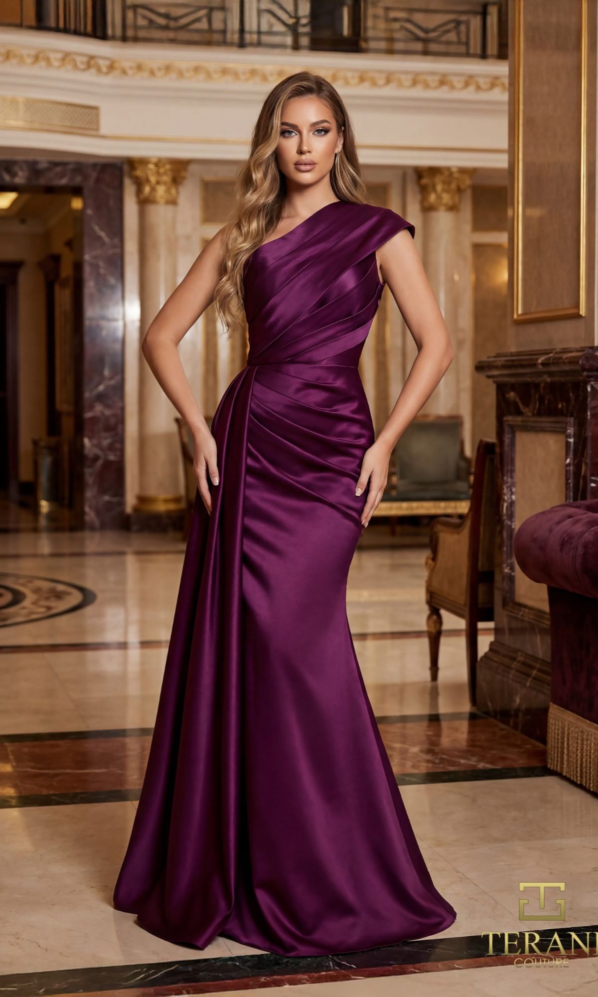 A woman stands in an elegant, marble-floored interior wearing the Terani 261M6411 long formal dress in deep purple satin, featuring a floor-length, one-shoulder design.